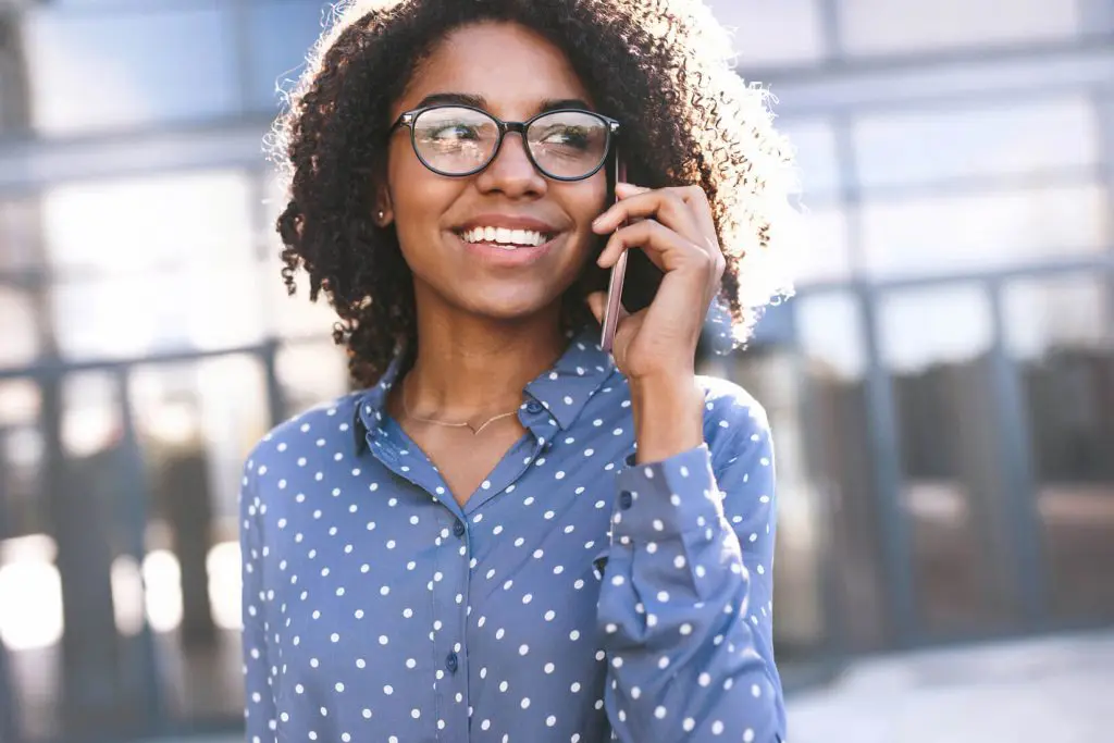 Photograph of woman smiling on the phone