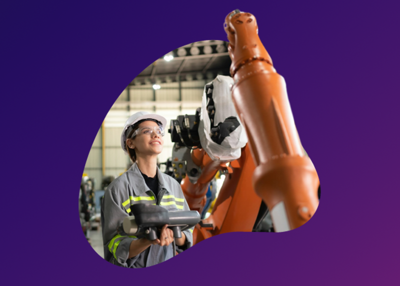 Photograph of worker in manufacturing plant surrounded by equipment