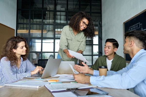 Photograph of sales team reviewing reports