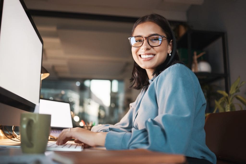 Photograph of office worker smiling to camera