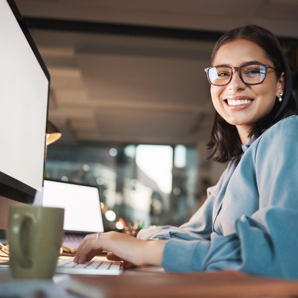 Photograph of office worker smiling to camera