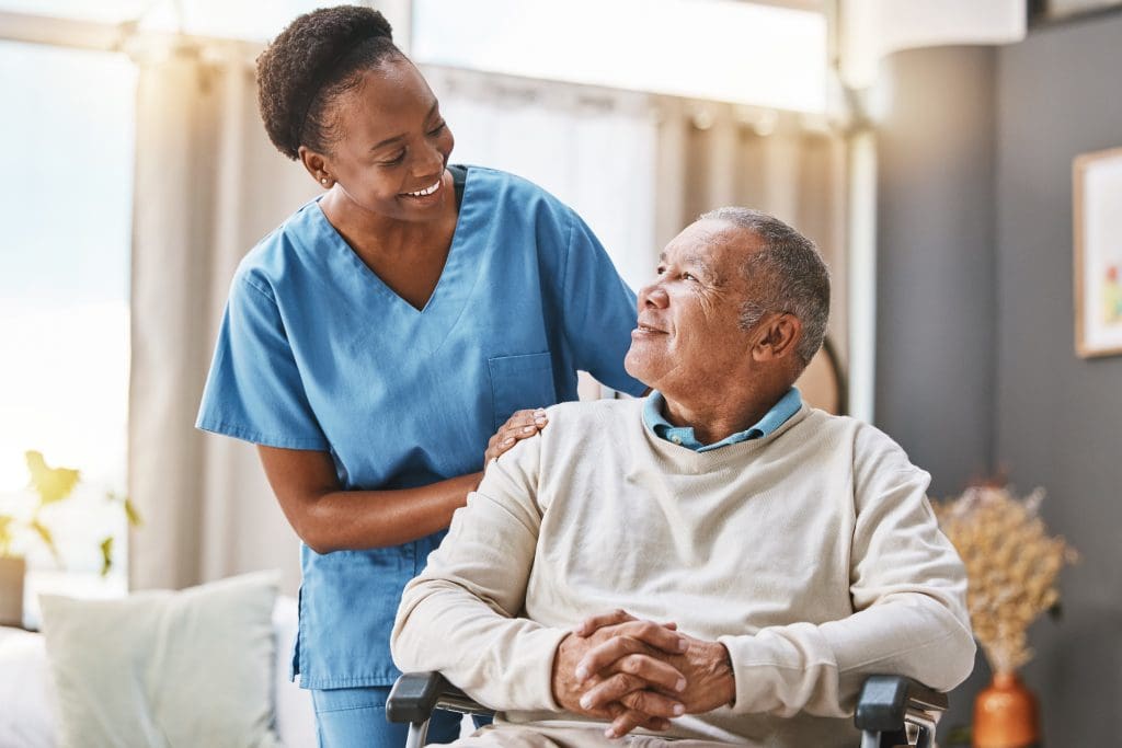 Photograph of elderly care worker and man in wheelchair
